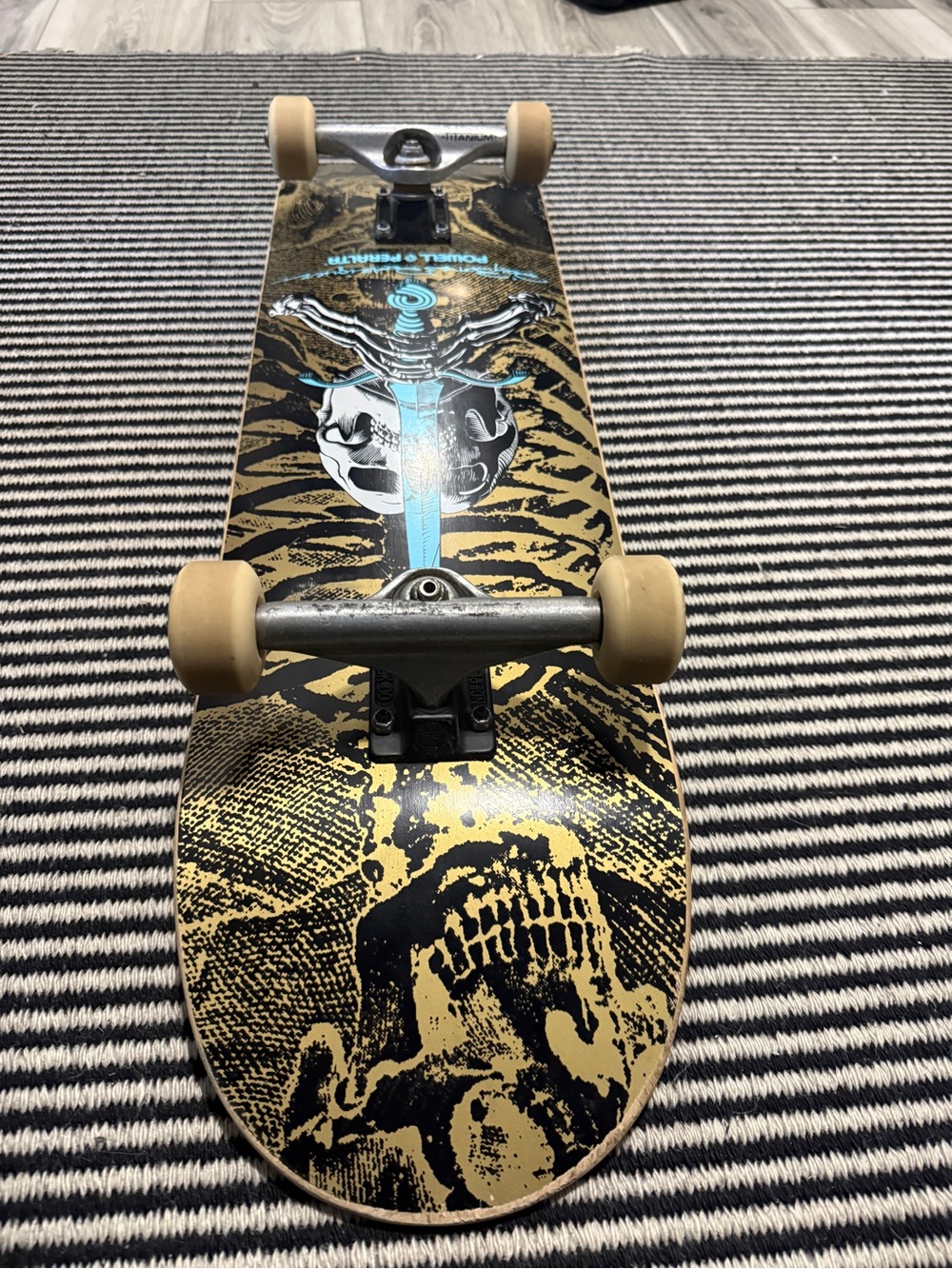 Skull Graphic Skateboard Deck in Black and Gold